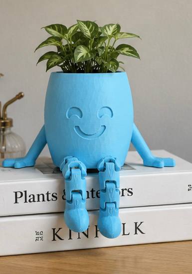 Detroit Plant Mom blue 3-inch 3D printed Hanging Buddy planter styled on books with a small houseplant